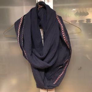 Infinity scarf with embroidered edge.